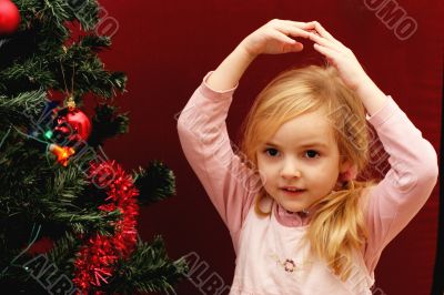 toddler girl and christmas tree