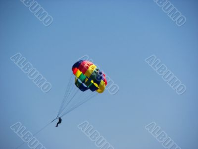 Man parasailing in the sky