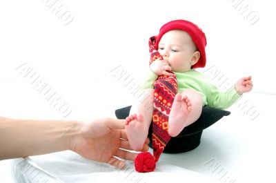 a little baby in a large red hut portrait