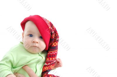 a little baby in a large red hut portrait