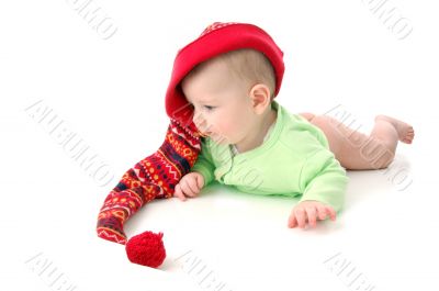 a little baby in a large red hut portrait