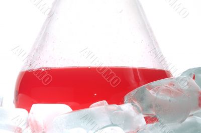 red liquid in Flask behind ice