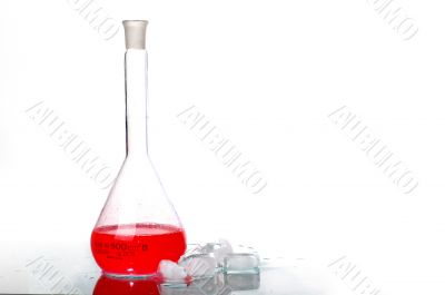 red liquid in Flask behind ice red liquid in Flask behind ice