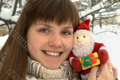 The girl with toy Santa Claus