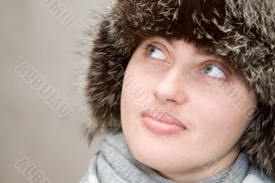 woman wearing a wool scarf and knit hat