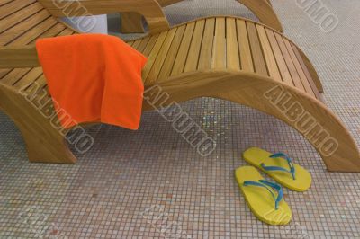 sunbed with towel  and yellow sandals near closeup