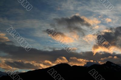 Sunset with clouds and mountains Sunset with clouds and mountains