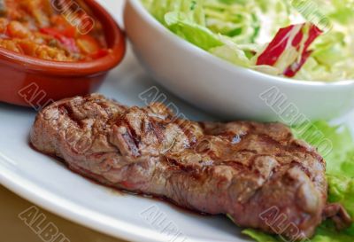 Beef steak blue with salad and ratatouille