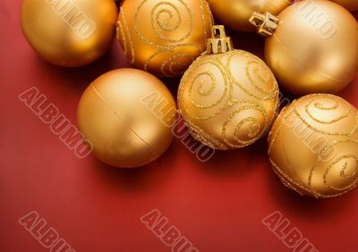 gold christmas baubles on red