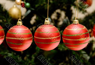 christmas baubles with tree in the background