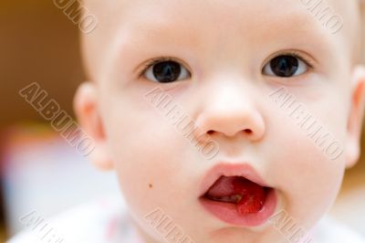 Baby eating apple. Children`s face close-up