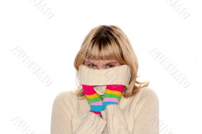 blond girl in Multi-coloured gloves is trying to hide