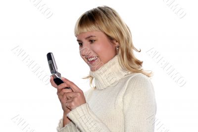 Young blond woman sms by mobile phone. She is happy