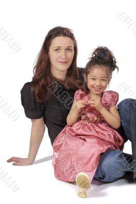 mother and daughter sit together and smile