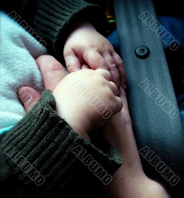 Hands of Baby in Car Seat
