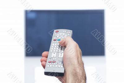 Hand with remote control and flat tv