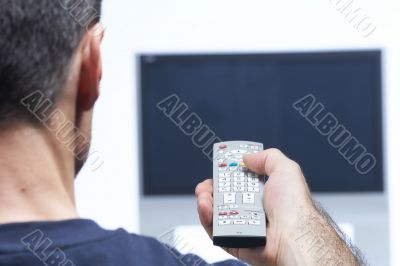 Man with remote control and flat tv