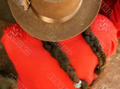Latina with plaited hair and hat