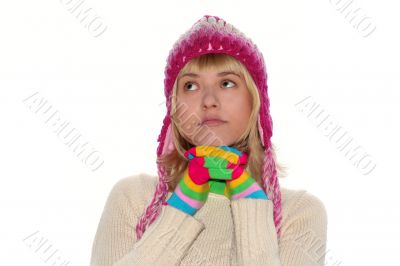 Thoughtful girl in pink cap and Multi-coloured gloves