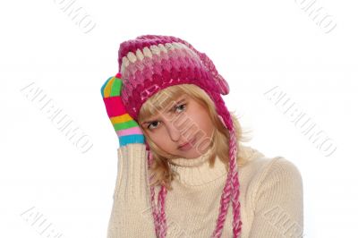 Thoughtful girl in pink cap and Multi-coloured gloves