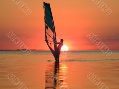 Silhouette of a windsurfer on waves of a gulf 4
