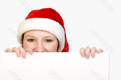 Christmas girl holding up a white sign for copyspace