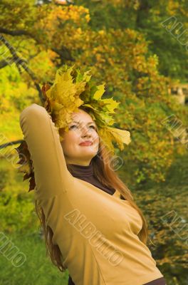 Portrait of the girl in a wreath from maple leaves