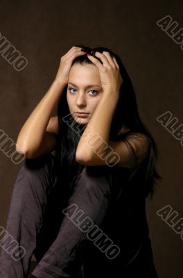 The sad beautiful girl on a dark background The sad beautiful girl on a dark background