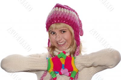 Smiling blond girl in cap and Multi-coloured gloves
