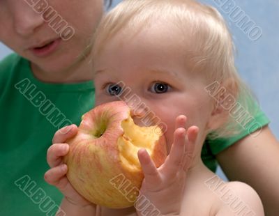 cute baby eats an apple