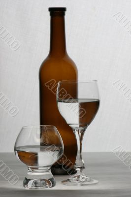 brown bottle and glasses brown bottle and glasses