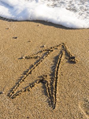 arrow on wet sea sand