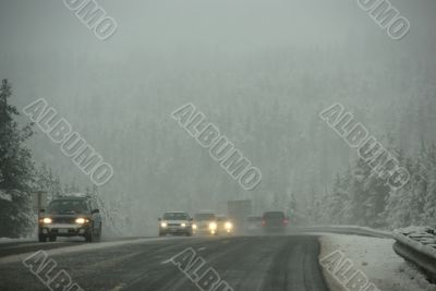 Traffic moving through fog