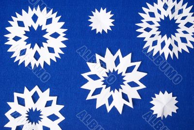 blu background with white papery snowflakes