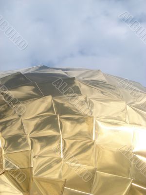 Golden church cupola mirroring surface