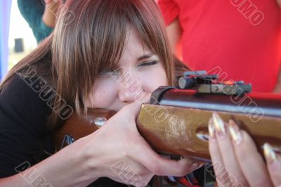 Female shooter taking aim close-up