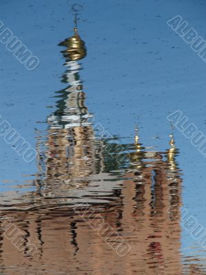 Church Cupola with Cross mirrored in waves