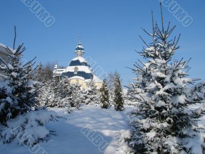 Winter snowy landscape with fur-trees and church