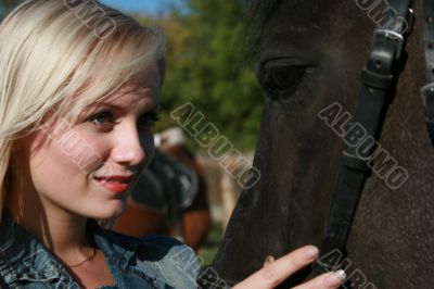 Blond female with brown horse close-up portrait