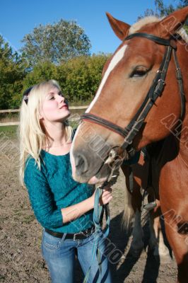 Blond female with brown horse close-up portrait Blond female with brown horse close-up portrait
