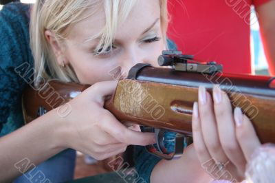 Female shooter taking aim close-up