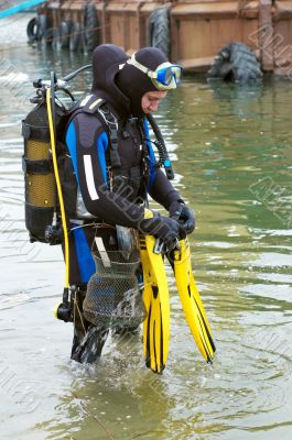 scuba diver entering the water