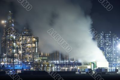 Oil refinery with cloudscape