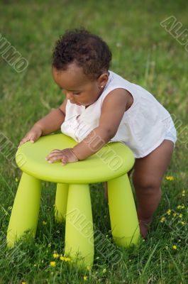 Toddler playing with chair