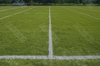 White boundary lines of football playing field