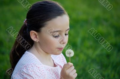 Girl blowing dandelion