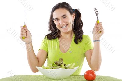 adolescent eating a salad