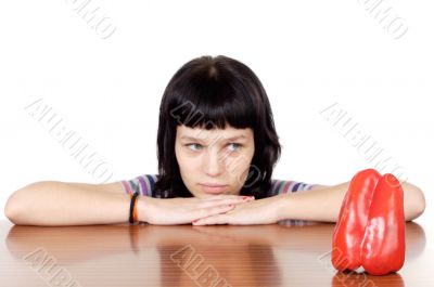 girl watching a red pepper