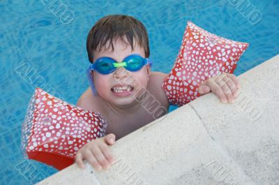 boy learning to swim