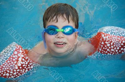 boy learning to swim